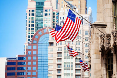 Low angle view of flag against buildings in city