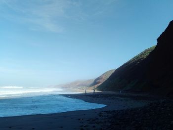 Scenic view of beach against blue sky