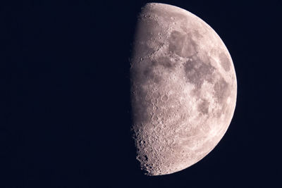 Low angle view of half moon against sky at night