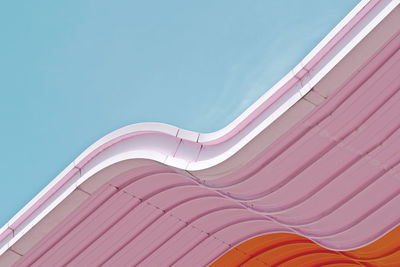 Low angle view of pink slide against sky