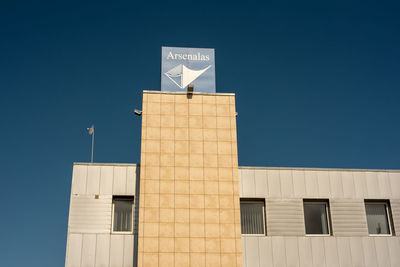 Low angle view of building against clear blue sky