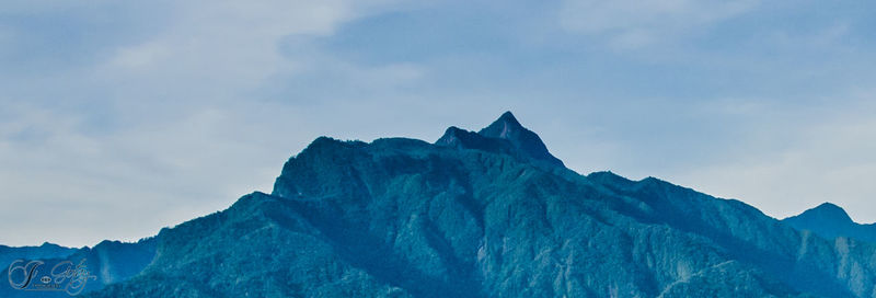 Low angle view of mountain range against sky