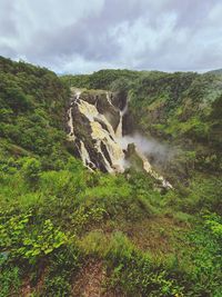 Scenic view of waterfall against sky