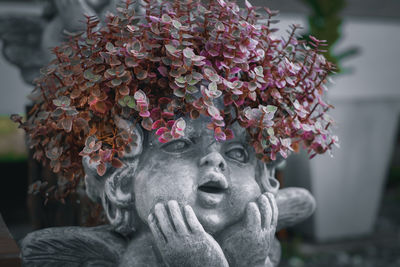 Close-up of statue of flowering plant