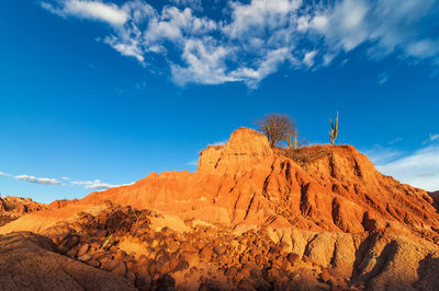 Scenic view of rocky mountains at tatacoa desert against blue sky