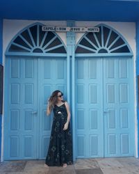 Woman standing against door