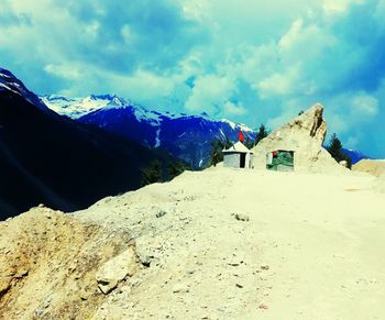 Scenic view of mountains against cloudy sky