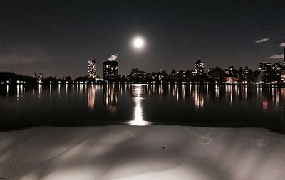 Reflection of illuminated buildings in water at night