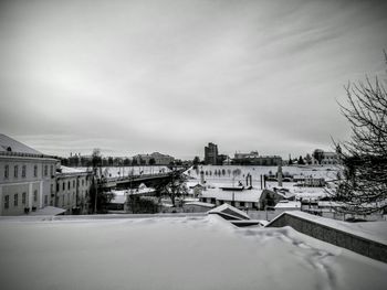 Snow covered buildings in city