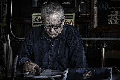 Midsection of man sitting on table
