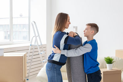 Side view of couple standing against the wall