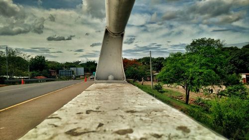 Road amidst trees in town against sky