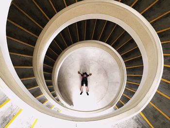 High angle view of man at bottom of spiral staircase