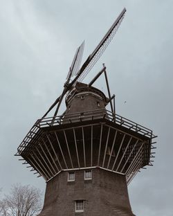 Low angle view of windmill against sky