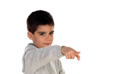 Portrait of boy standing against white background