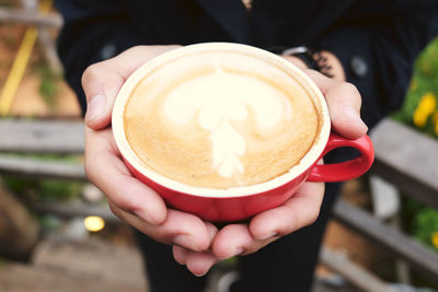 Midsection of person holding coffee cup