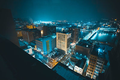 High angle view of illuminated cityscape against sky at night