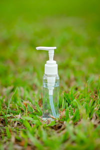 Close-up of white bottle on field