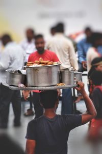 Rear view of people standing at market