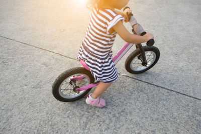 High angle view of girl riding bicycle on street