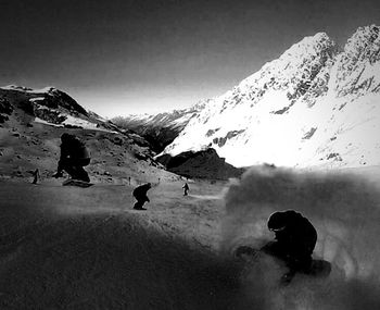 People skiing on snow covered landscape