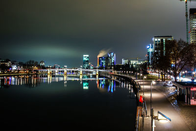 Illuminated cityscape against sky at night