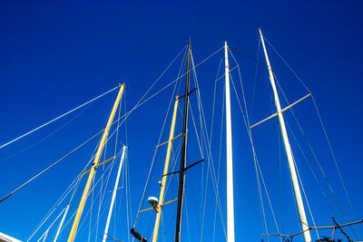 Low angle view of sailboat against blue sky