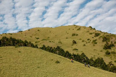 Clouds, glass, hikers and mountains.