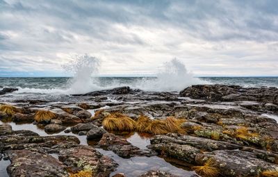 Sea waves splashing on rocks at beach
