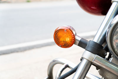 Close-up of bicycle wheel by road in city