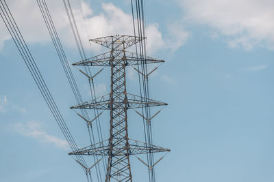 Low angle view of electricity pylon against sky