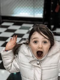 Portrait of shocked girl at home