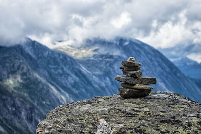 Stack of rocks on mountain against sky