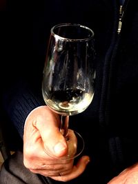 Close-up of hand holding wineglass