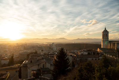 As the sun sets over the medieval walls of girona in catalunya, spain, 