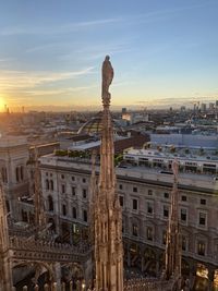 Statue of milano duomo against sky during sunset