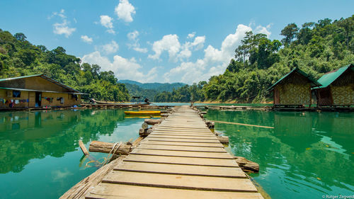 Pier over lake against sky