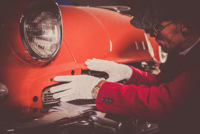 Cropped hand of man holding car