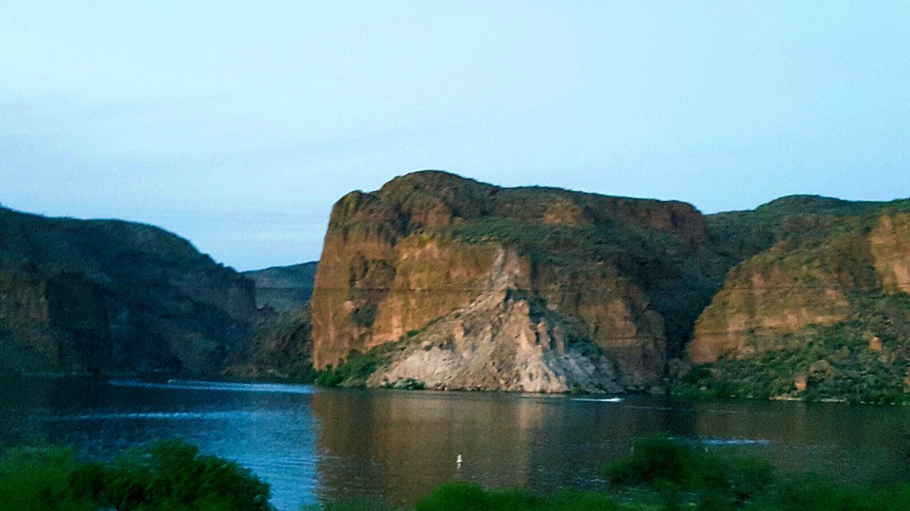 water, tranquil scene, tranquility, scenics, mountain, rock formation, clear sky, beauty in nature, rock - object, nature, cliff, copy space, geology, rock, idyllic, waterfront, sea, lake, rocky mountains, physical geography