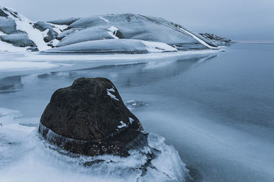 Stone at frozen coastline, sweden