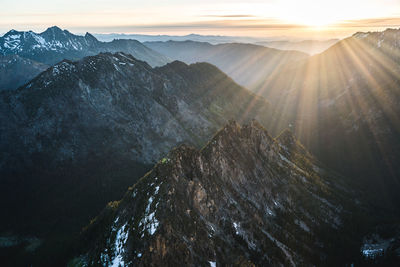 Scenic view of snowcapped mountains against sky during sunset