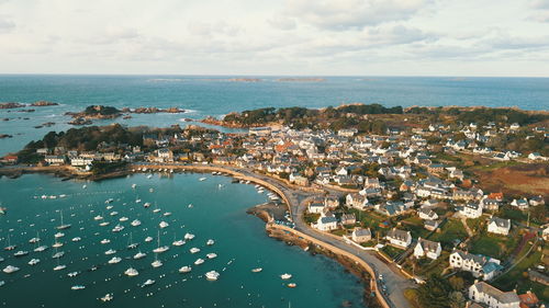 High angle view of townscape by sea against sky