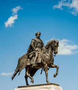 Low angle view of statue against sky