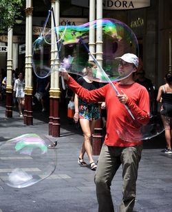 Man with multi colored umbrellas at music concert