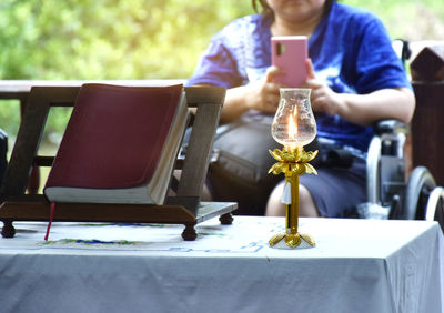 Midsection of woman sitting on table