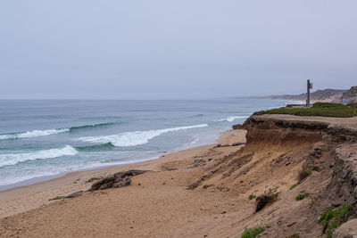 Scenic view of beach against clear sky