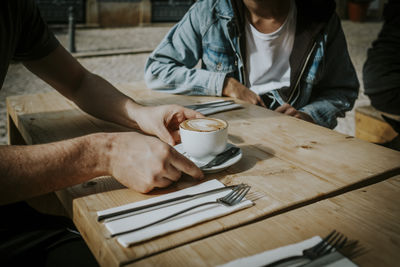 Man with coffee cup on table