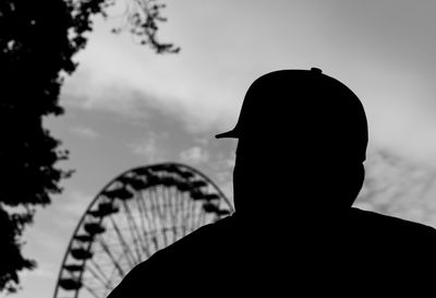 Rear view of silhouette person at amusement park