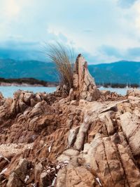 Rock formations in sea against sky