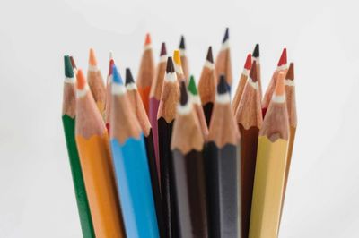 Close-up of colored pencils against white background